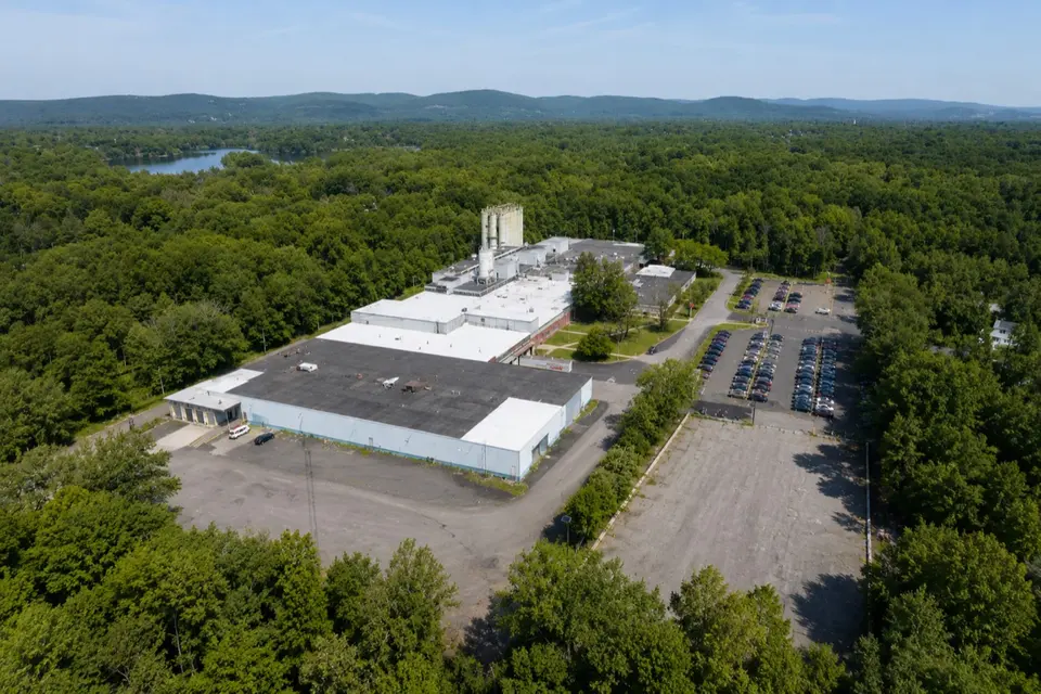 Aerial view of 55 Haul Road, Wayne, showing the industrial building and surrounding acreage